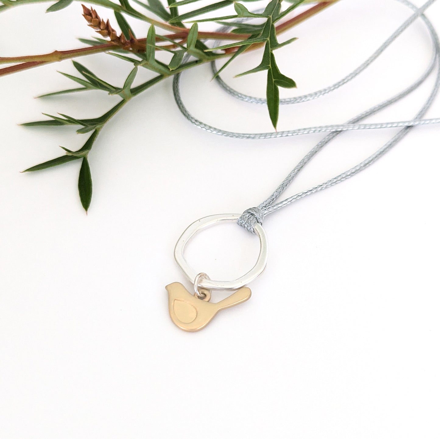 Winged bird flat ring cord necklace
