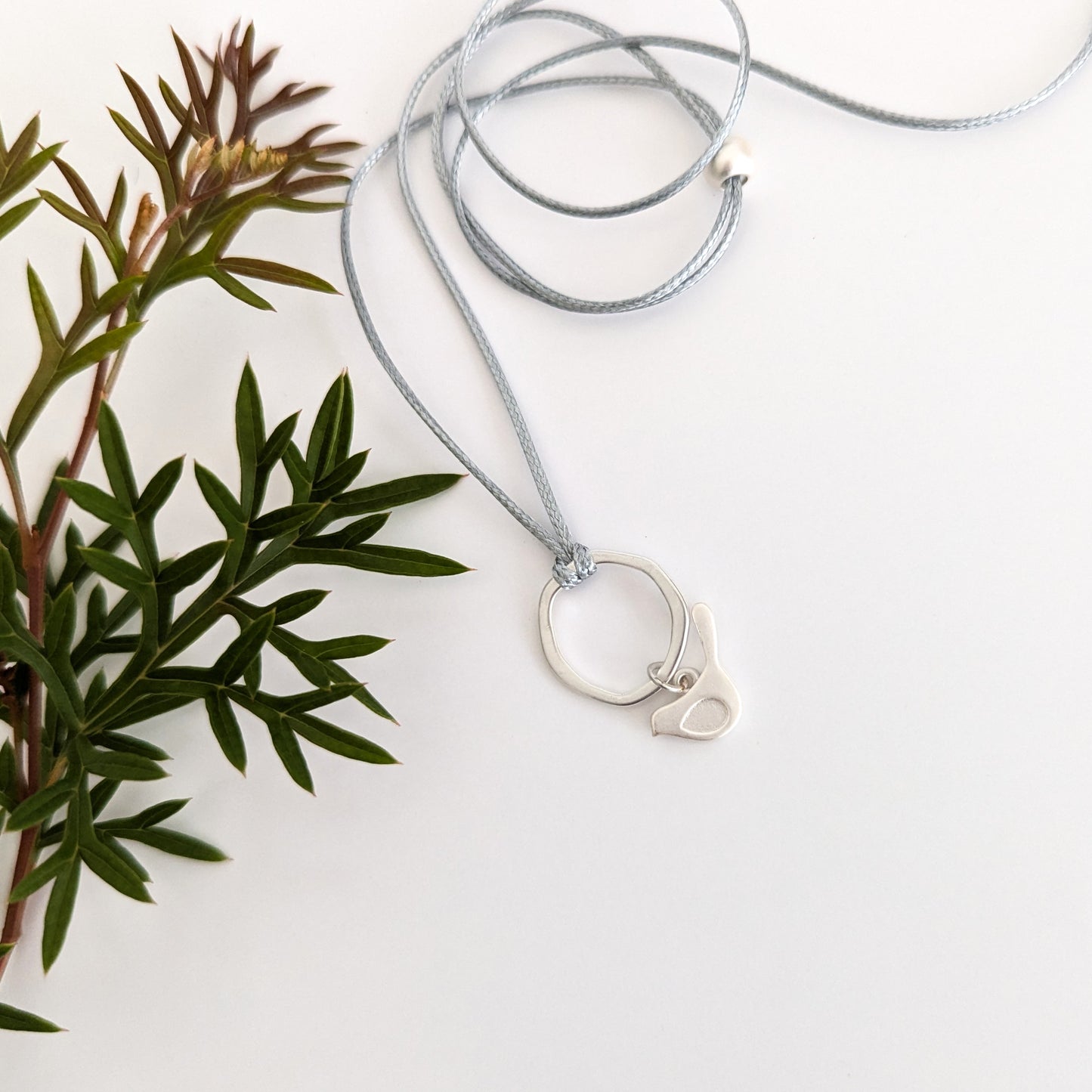 Winged bird flat ring cord necklace