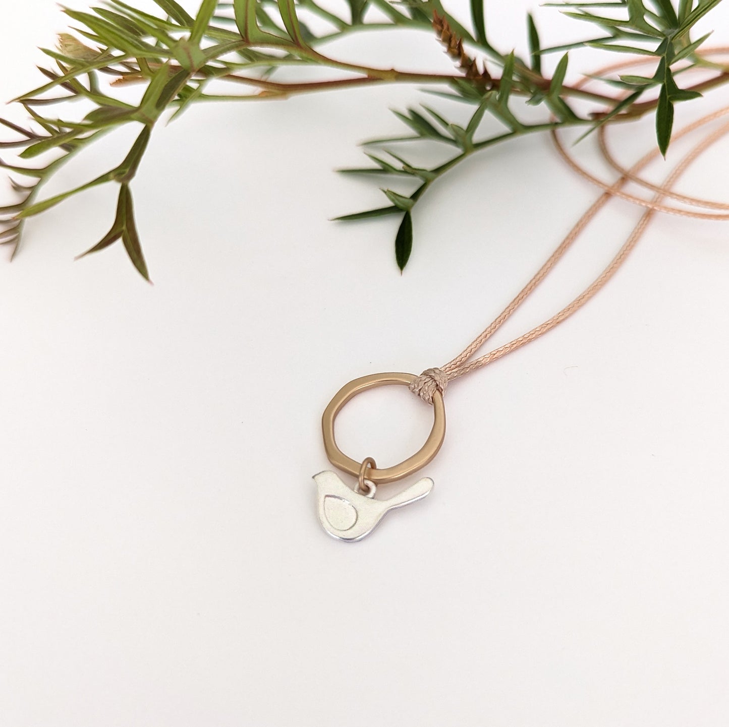 Winged bird flat ring cord necklace