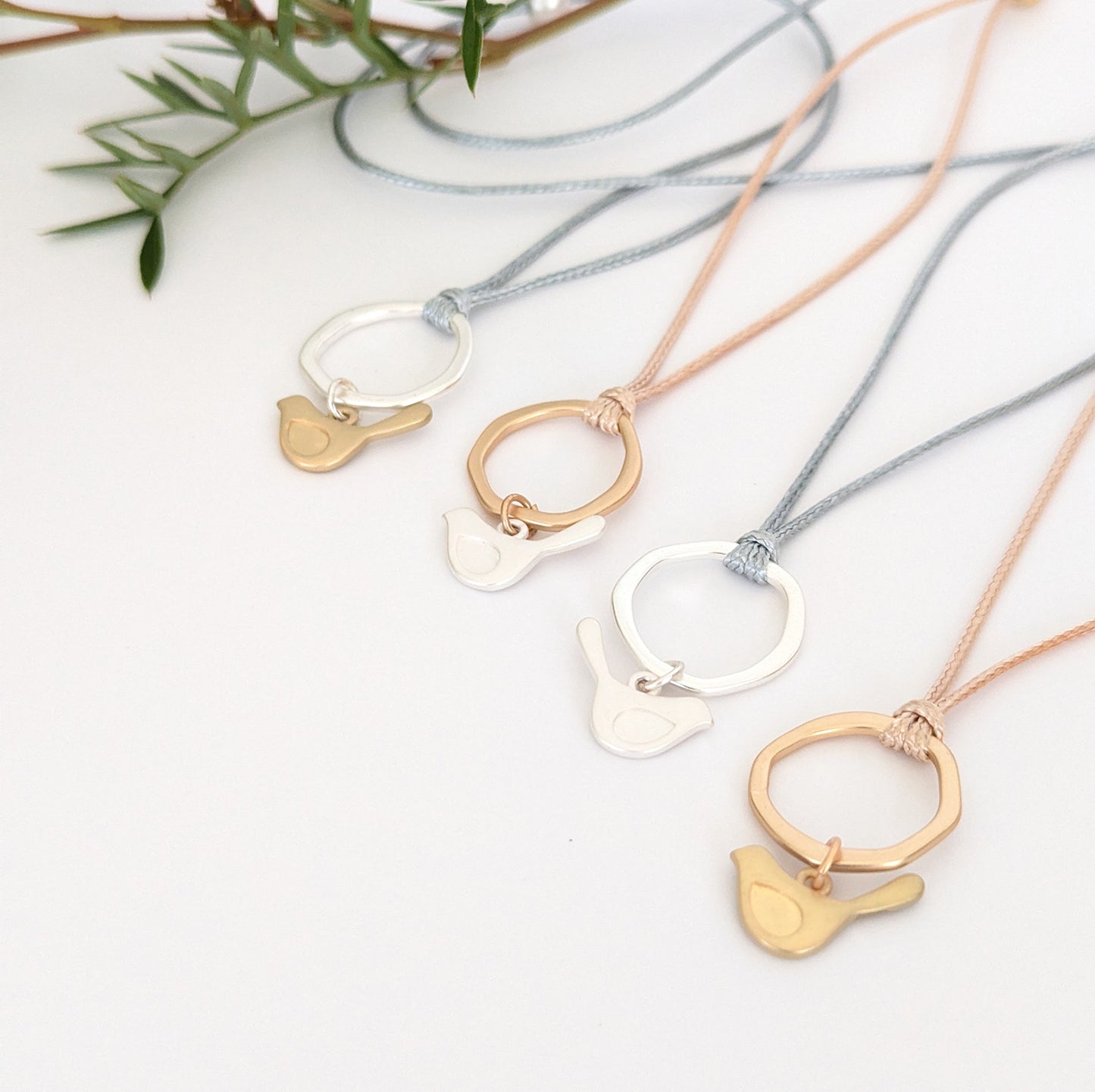 Winged bird flat ring cord necklace